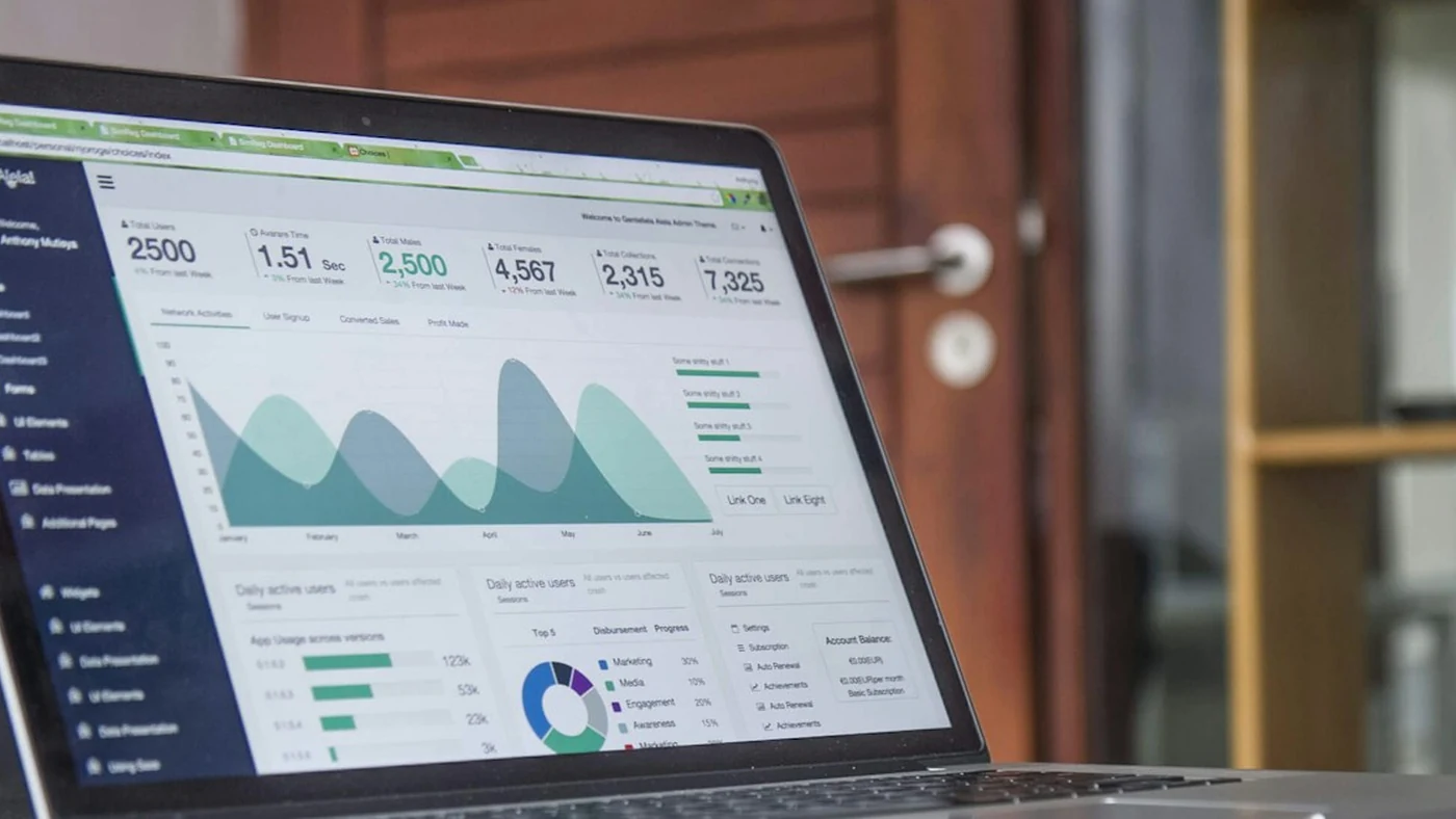A laptop displaying an analytics dashboard on a desk