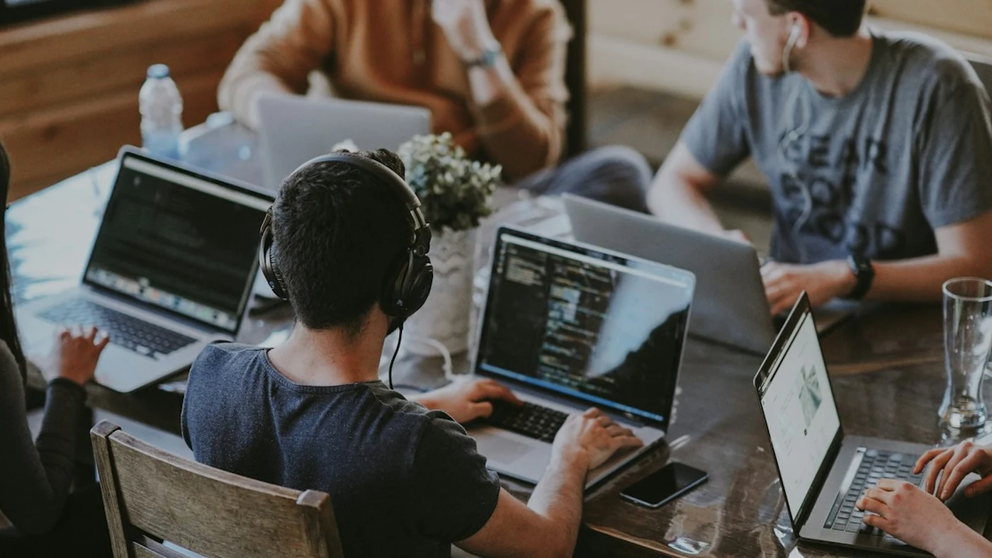 A team working together on laptops around a table